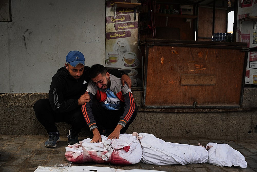 | Photo: AP/Abdel Kareem Hana : Yahya Eid mourns over the body of his 10-year-old nephew, Shabaan Eid, who was killed in an Israeli army strike on the Bureij camp, during his funeral at Al-Awda Hospital in Nuseirat, central Gaza Strip, Wednesday, Oct. 29, 2025. 