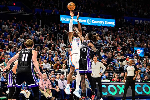 Oklahoma City Thunder guard Shai Gilgeous-Alexander (2) shoots against Sacramento Kings guard Keon Ellis (23) during the second half of an NBA basketball game in Oklahoma City. 