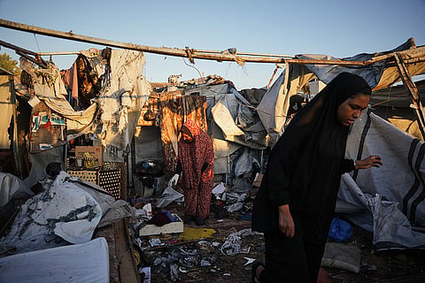 Displaced Palestinians inspect the damage after an Israeli army strike on their tent camp in Deir al-Balah, Gaza Strip, Wednesday, Oct. 29, 2025.
