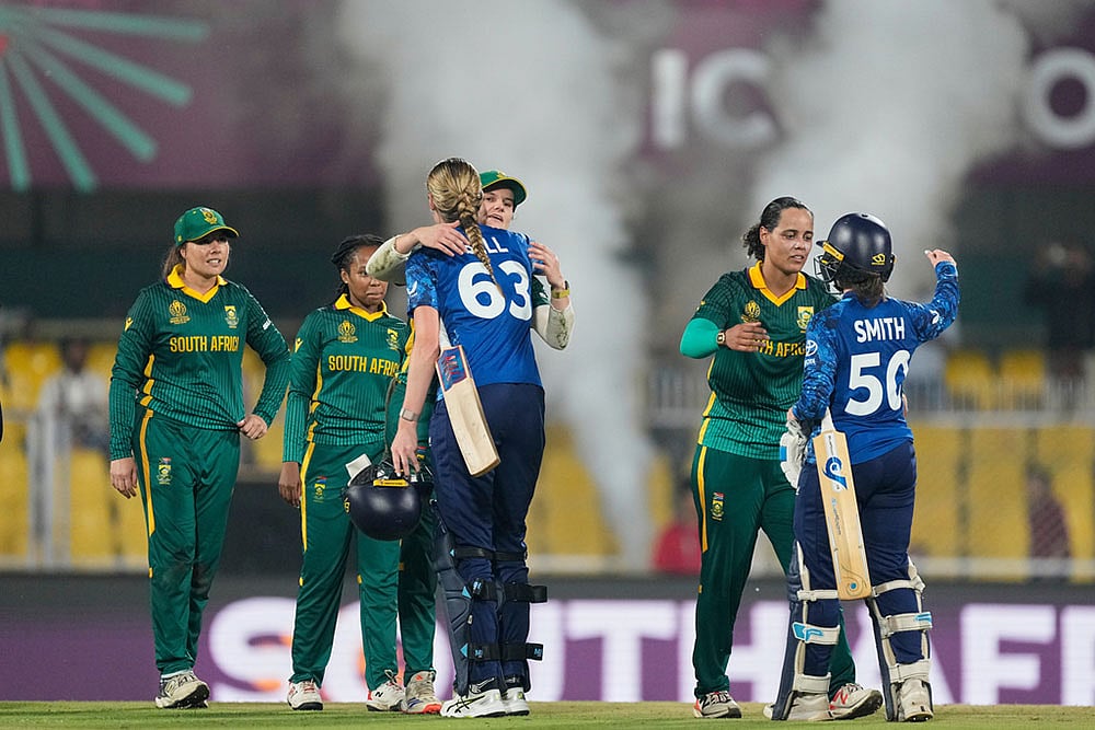| Photo: AP/Anupam Nath : South Africa's players with England's players celebrate after winning the ICC Women's Cricket World Cup first semifinal match between England and South Africa at Barsapara Cricket Stadium in Guwahati.