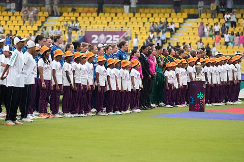 England and South Africa's players stand for their national anthems before start the ICC Women's Cricket World Cup first semifinal match between England and South Africa at Barsapara Cricket Stadium in Guwahati.