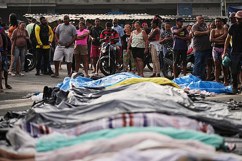 Brazil Gang Raid: People look at the bodies lined up by residents of those killed the day before during a police raid targeting the Comando Vermelho gang in the Complexo da Penha favela of Rio de Janeiro, Brazil.