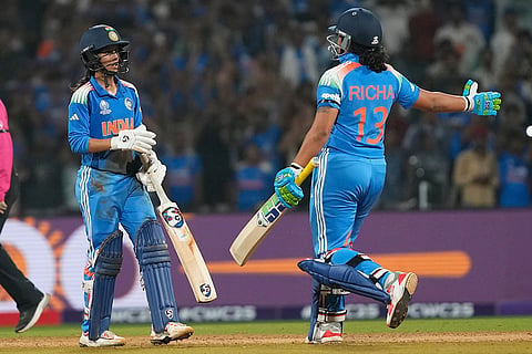 India's Jemimah Rodrigues, left, celebrates her century with India's Richa Ghosh during the ICC Women's Cricket World Cup cricket semi final match between India and Australia at DY Patil Stadium in Navi Mumbai.
