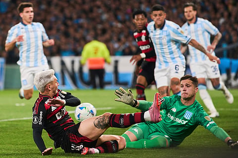 Guillermo Varela of Brazil's Flamengo, left, and goalkeeper Facundo Cambeses of Argentina's Racing Club battle for the ball during a Copa Libertadores semifinal second leg soccer match in Buenos Aires, Argentina.