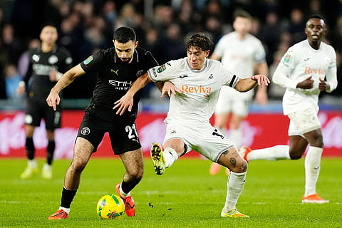 Swansea City vs Manchester City: Manchester City's Rayan Ait-Nouri, left, and Swansea City's Goncalo Franco battle for the bal during the English League Cup fourth round soccer match between Swansea City and Manchester City in Swansea, Wales.