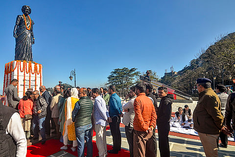 People pay tribute to a statue of former prime minister Indira Gandhi on her death anniversary, at the Ridge, in Shimla.