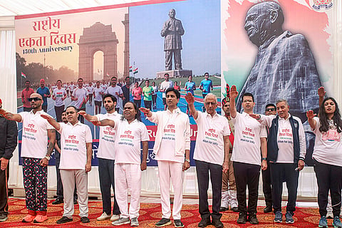 Poet Kumar Vishwas, cricketer Bhuvneshwar Kumar and others take a pledge during the 'Run for Unity' event on the 150th birth anniversary of the country's first home minister Sardar Vallabhbhai Patel, observed as 'Rashtriya Ekta Diwas', in Noida.