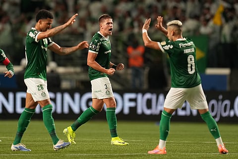 Bruno Fuchs of Brazil's Palmeiras, center, celebrates after scoring his side's second goal against Ecuador's Liga Deportiva Universitaria during a Copa Libertadores semifinal second leg soccer match in Sao Paulo.