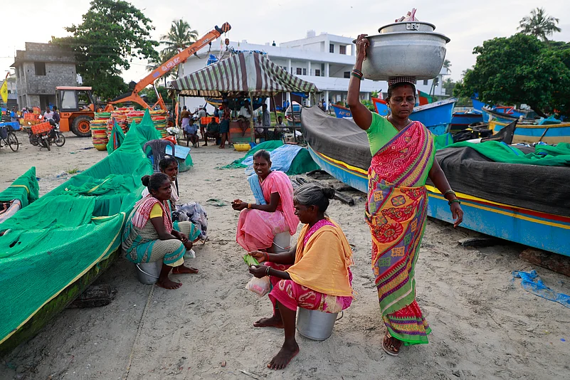 Women fish vendors are at the Chellanam Fishing Harbour on the outskirts of Kochi