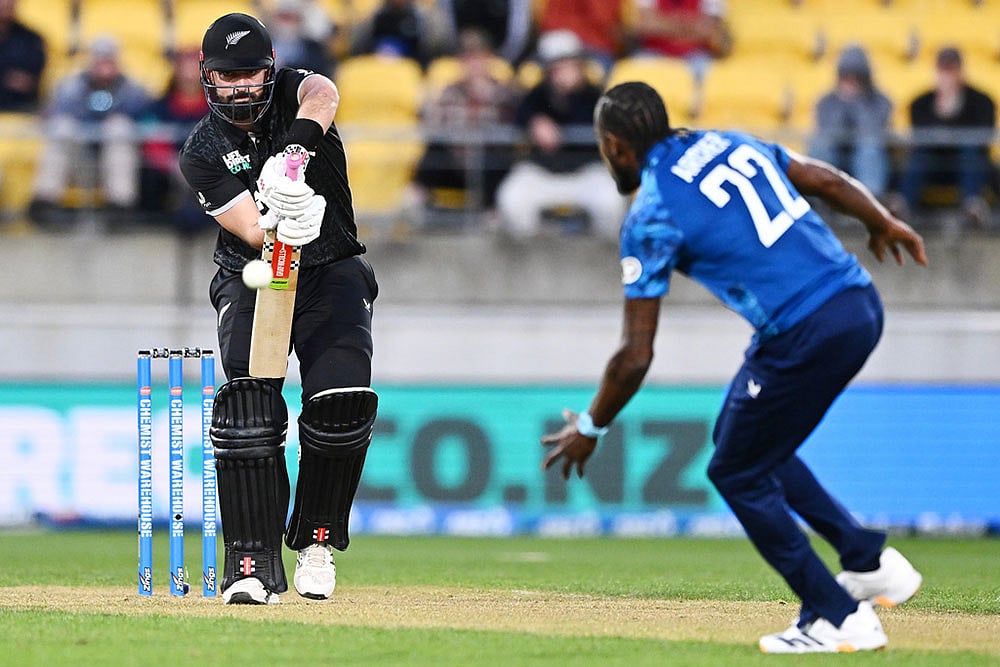 | Photo: Kerry Marshall/Photosport via AP : Daryl Mitchell of New Zealand plays the ball towards England's Jofra Archer during the One Day International cricket match between New Zealand and England in Wellington, New Zealand.