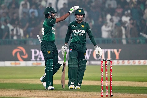 Pakistan's Saim Ayub, right, is congratulated by Babar Azam after his fifty during the second T20 cricket match between Pakistan and South Africa, in Lahore, Pakistan.