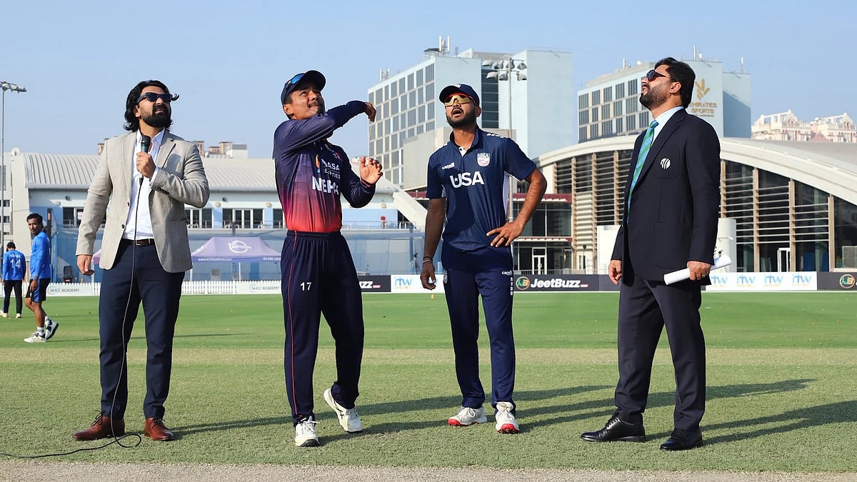 Photo: X/CricketNep : Rohit Paudel spins the coin before the start of the Nepal vs USA, ICC Cricket World Cup League 2 match in Dubai.