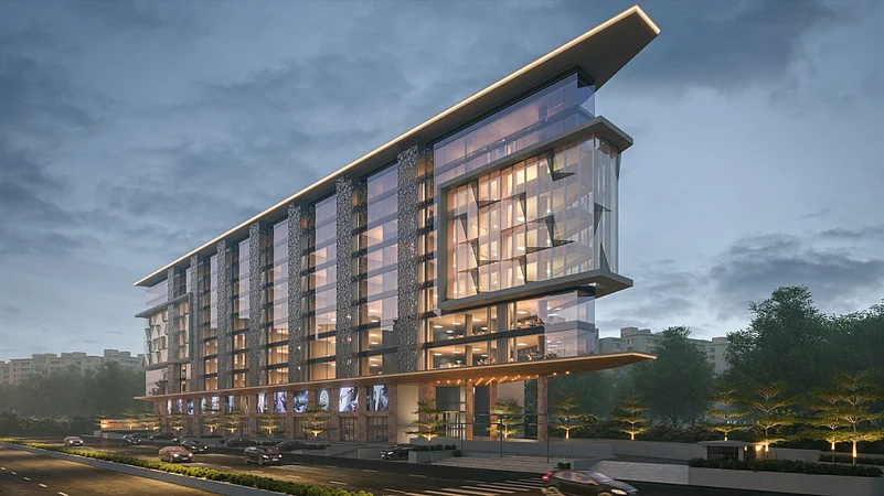 Modern glass building with lights along a city road at dusk