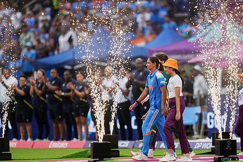 India's captain Harmanpreet Kaur, centre, comes out before start the ICC Women's Cricket World Cup final match between India and South Africa in Navi Mumbai.