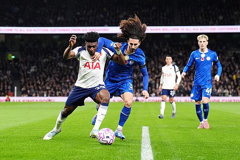 Tottenham Hotspur's Mohammed Kudus, left, attempts to go past Chelsea's Marc Cucurella during the English Premier League soccer match between Tottenham Hotspur and Chelsea in London.