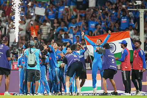 India's players celebrate after winning the ICC Women's Cricket World Cup final match between India and South Africa in Navi Mumbai.