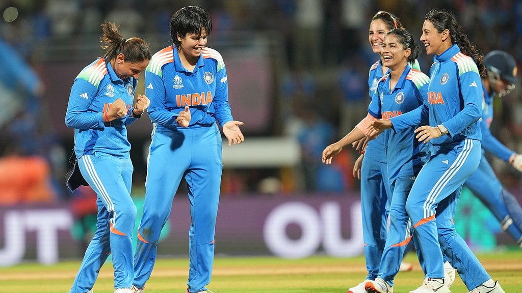 Photo: AP : Captain Harmanpreet Kaur, left, and Shafali Verma, centre, celebrate the dismissal of Sune Luus during the ICC Women's Cricket World Cup final between India and South Africa in Navi Mumbai.