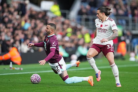 Burnley's Kyle Walker, left, and Arsenal's Riccardo Calafiori in action during the English Premier League soccer match between Burnley and Arsenal in Burnley, England.