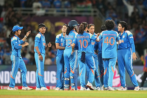 India's players celebrate the dismissal of South Africa's Sinola Jafta during the ICC Women's Cricket World Cup final match between India and South Africa in Navi Mumbai.