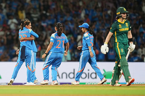 India's players celebrate the dismissal of South Africa's Anneke Bosch during the ICC Women's Cricket World Cup final match between India and South Africa in Navi Mumbai.
