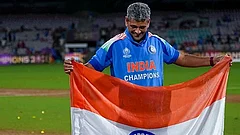 India’s coach Amol Muzumdar plants the Indian tricolour on the pitch after the team won the ICC Women's World Cup 2025, at the DY Patil Stadium, in Navi Mumbai. - | Photo: PTI/Kunal Patil
