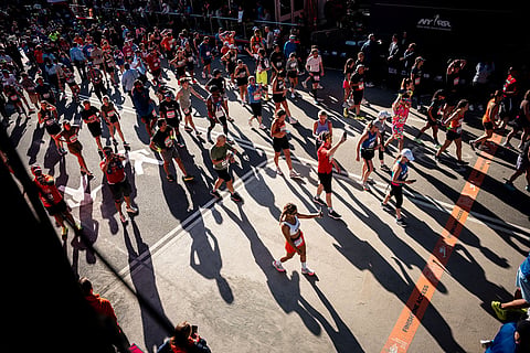 Runners cross the finish line in Central Park at the New York City Marathon in New York. 