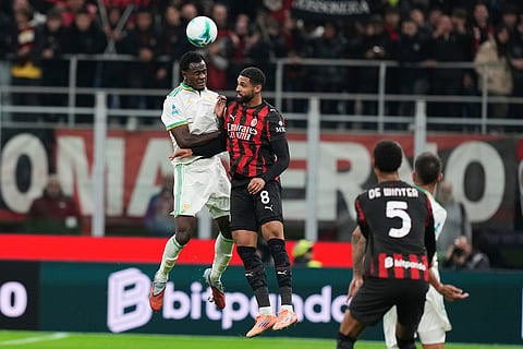 Roma's Evan Ndicka, left, and AC Milan's Ruben Loftus-Cheek challenge for the ball during the Serie A soccer match between AC Milan and Roma in Milan, Italy.