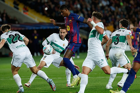 Barcelona's Marcus Rashford, center, attempts a shot at goal and misses during a Spanish La Liga soccer match between FC Barcelona and Elche CF in Barcelona, Spain.