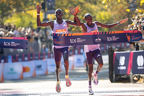 Benson Kipruto and Alexander Mutiso cross the finish line to win first and second place in the men's elite division of the New York City Marathon in New York. 