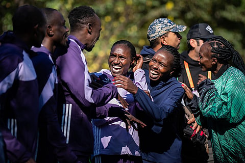 The six winners of the men's and women's elite divisions, celebrate together before the medal ceremony after winning the New York City Marathon in New York. 