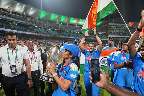 India's players with the winning trophy after their win over South Africa in the ICC Women's Cricket World Cup final match in Navi Mumbai.