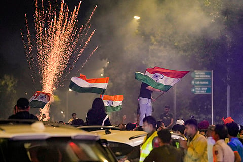 People celebrate after the Indian cricket team won the ICC Women's World Cup 2025, near the India Gate, in New Delhi.