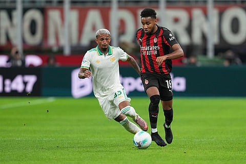 Roma's Wesley, left, and AC Milan's Christopher Nkunku challenge for the ball during the Serie A soccer match between AC Milan and Roma in Milan, Italy.