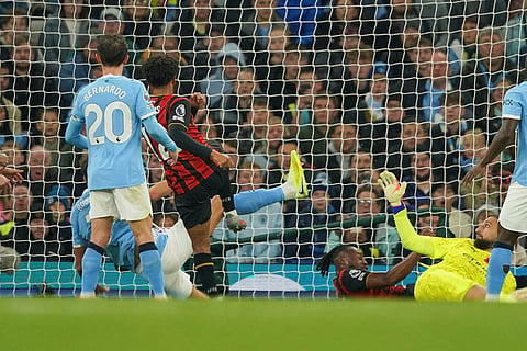 Bournemouth's Tyler Adams, center left, scores his side's opening goal during the English Premier League soccer match between Manchester City and Bournemouth in Manchester, England.