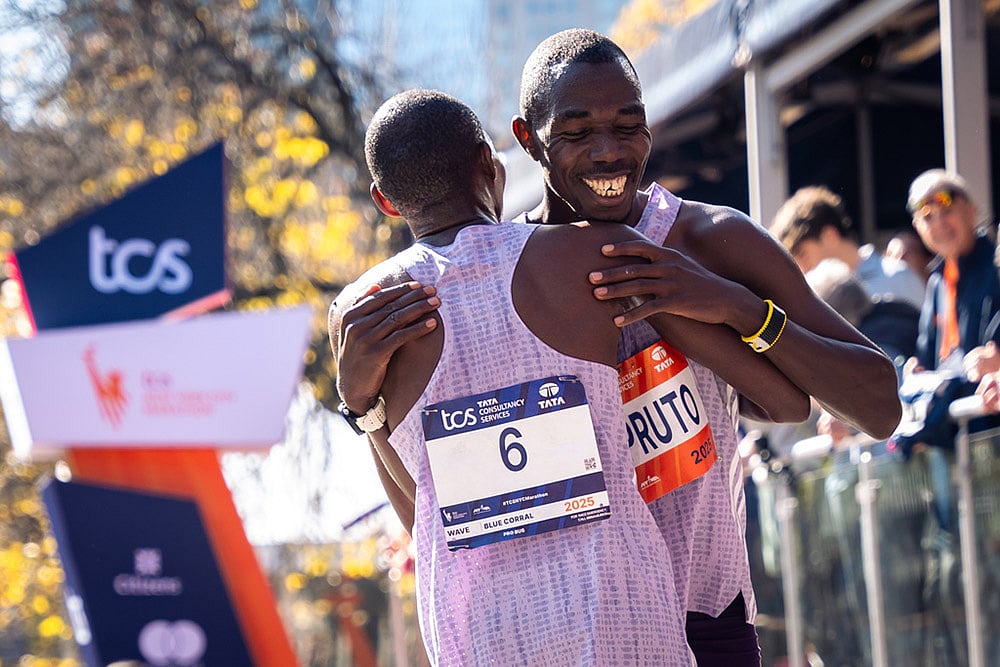 Benson Kipruto and Alexander Mutiso and hug and laugh with each other after a close finish crossing the finish line to win first and second place in the men's elite division of the New York City Marathon in New York.  - | Photo: AP/Angelina Katsanis