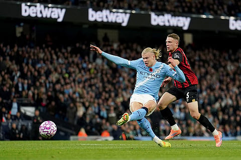 Manchester City's Erling Haaland scores his sides first goal during the English Premier League soccer match between Manchester City and Bournemouth in Manchester, England.