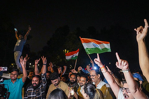 People celebrate after the Indian cricket team won the ICC Women's World Cup 2025, near the India Gate, in New Delhi.