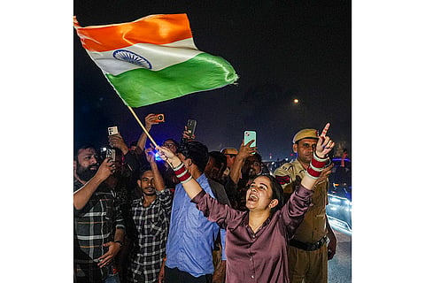 People celebrate after the Indian cricket team won the ICC Women's World Cup 2025, near the India Gate, in New Delhi.
