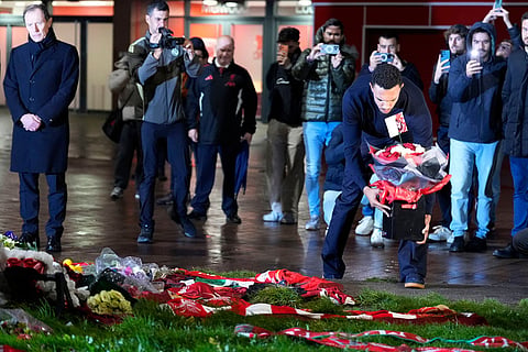 Real Madrid's Trent Alexander-Arnold lays a tribute at the Diogo Jota memorial outside Anfield, Liverpool, England.