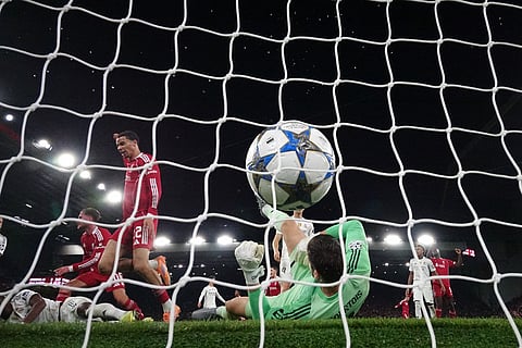 Liverpool's Alexis Mac Allister, left, scores during the Champions League soccer match between Liverpool and Real Madrid in Liverpool, England.