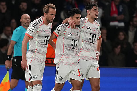 Bayern's Luis Diaz, center, celebrates with team mates Josip Stanisic, right, and Harry Kane after scoring his side's second goal during the Champions League opening phase soccer match between Paris Saint-Germain and Bayern Munich in Paris, France.