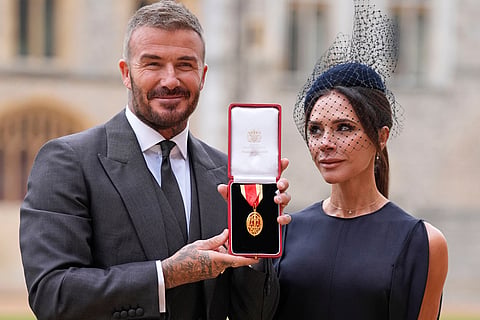Sir David Beckham, with his wife Lady Victoria, after he was made a Knight Bachelor at an investiture ceremony at Windsor Castle, Berkshire, England.
