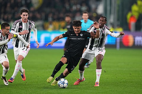 Juventus' Jonathan David, right, vies for the ball with Sporting's Maximiliano Araujo during the Champions League opening phase soccer match between Juventus and Sporting CP in Turin, Italy.