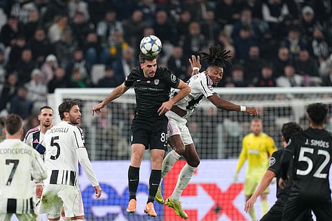 Sporting's Fotis Ioannidis, center, jumps for the ball with Juventus' Khephren Thuram, center right, during the Champions League opening phase soccer match between Juventus and Sporting CP in Turin, Italy.