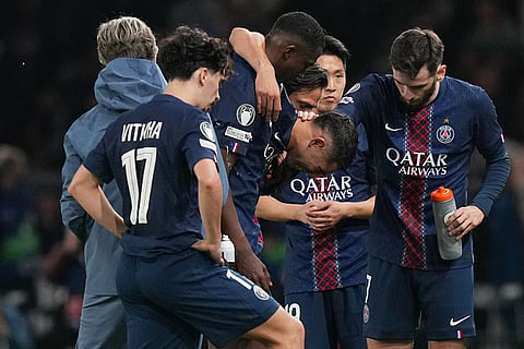 PSG's Achraf Hakimi leaves the field injured during the Champions League opening phase soccer match between Paris Saint-Germain and Bayern Munich in Paris, France.