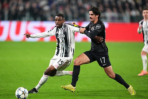 Sporting's Francisco Trincao fights for the ball with Juventus' Pierre Kalulu, left, during the Champions League opening phase soccer match between Juventus and Sporting CP in Turin, Italy.