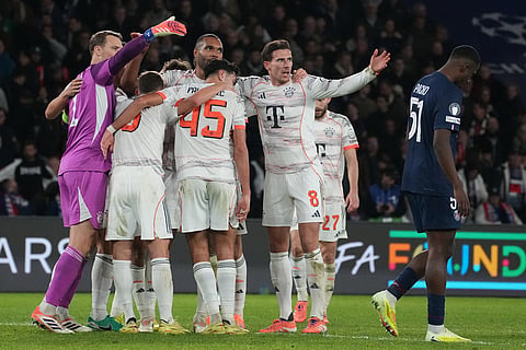 Bayern's goalkeeper Manuel Neuer, left, celebrates with team mates after the Champions League opening phase soccer match between Paris Saint-Germain and Bayern Munich in Paris, France.