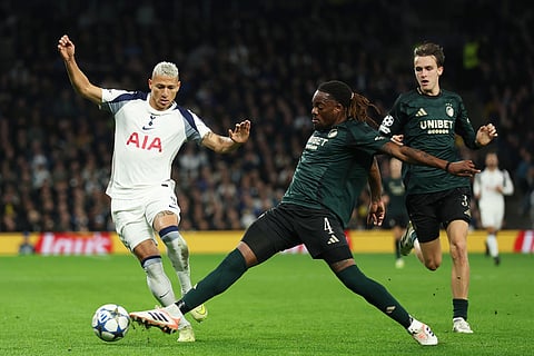 Tottenham's Richarlison, left, duels for the ball with Copenhagen's Munashe Garananga during the Champions League opening phase soccer match between Tottenham and Copenhagen, in London, England.