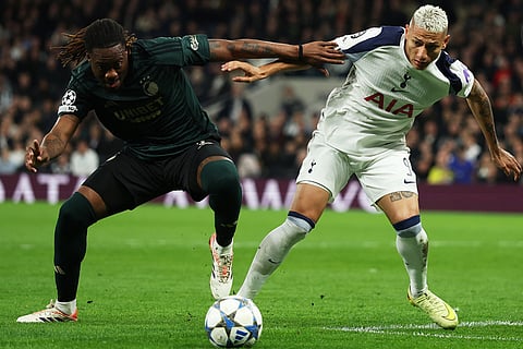 Tottenham's Richarlison, right, duels for the ball with Copenhagen's Munashe Garananga during the Champions League opening phase soccer match between Tottenham and Copenhagen, in London, England.