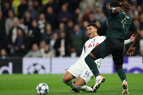 Tottenham's Dane Scarlett, left, duels for the ball with Copenhagen's Munashe Garananga during the Champions League opening phase soccer match between Tottenham and Copenhagen, in London, England.